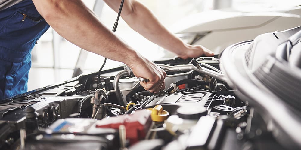 Mechanic Repairing A Car Engine